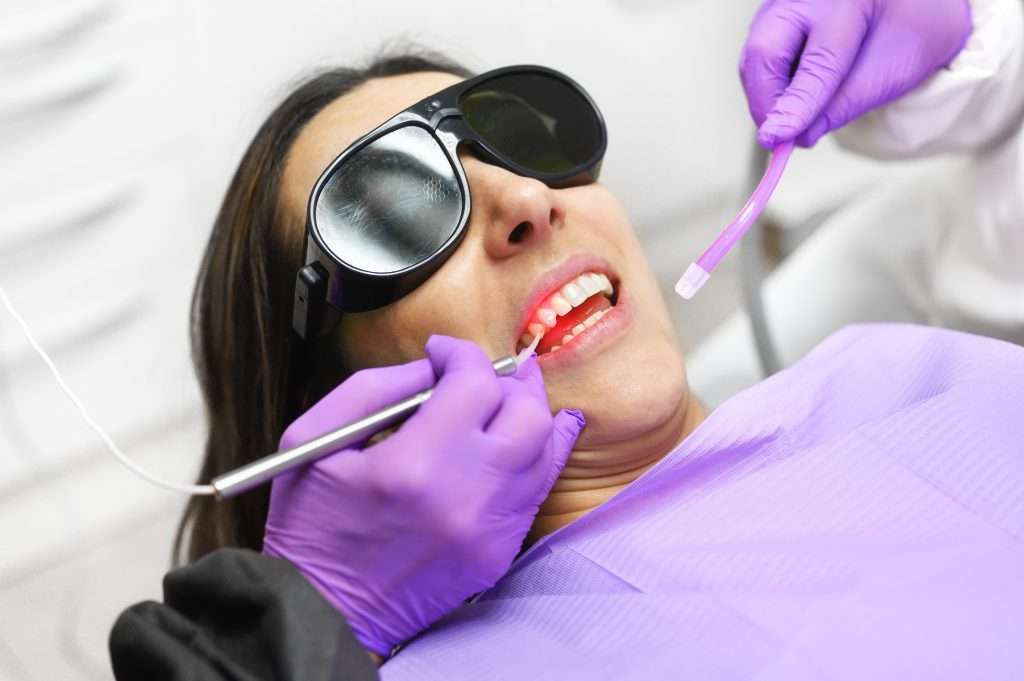 Woman receiving laser assisted dental treatment