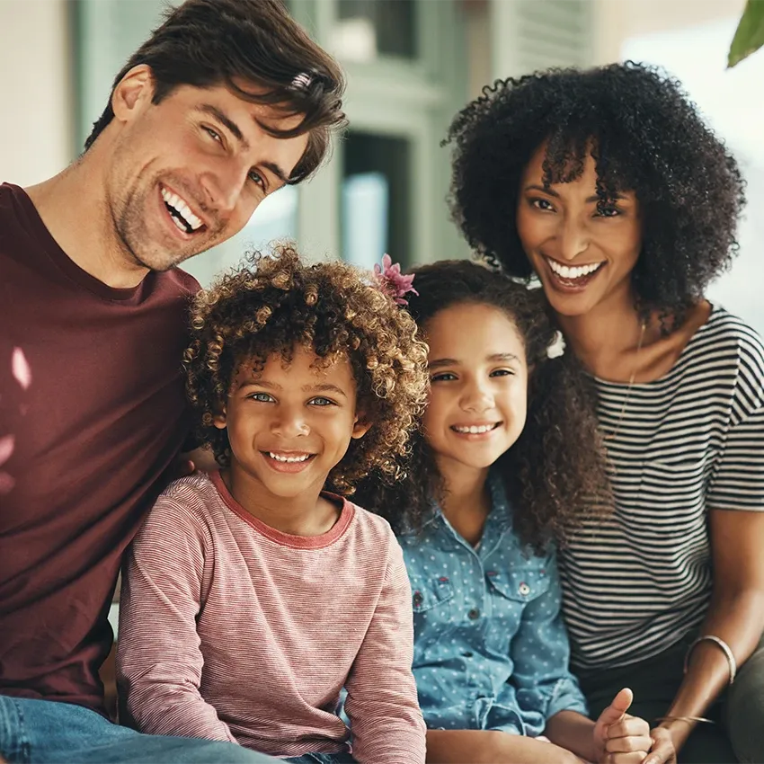 Smiling family of four together